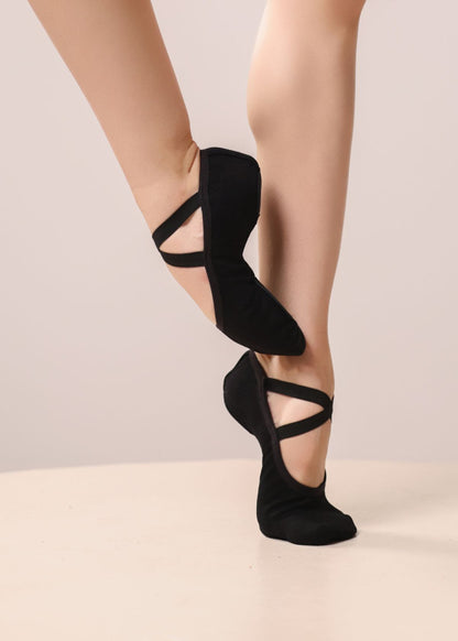 Black ballet slippers with elastic ankle straps, shown on a dancer's feet - RELEVE Stretch Ballet & Dance Shoes – Side View